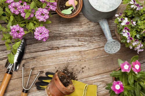 Gardener reviewing a service concern in a garden setting
